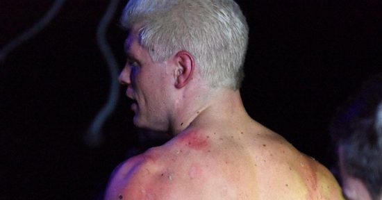 Cody Rhodes suplexes Andrade El Idolo through a flaming table; Photos of Cody's back